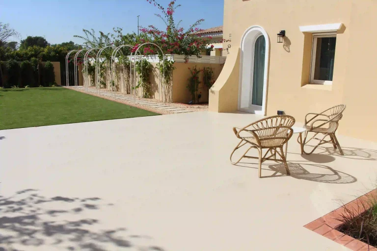 Landscape design with artificial turf and stepping-stone pavers in a Dubai villa garden