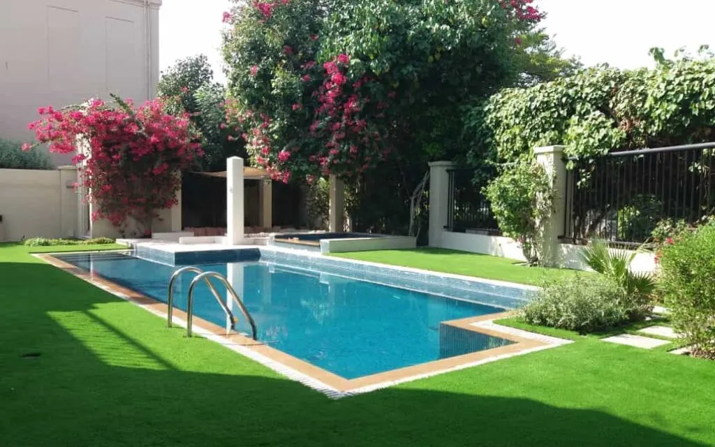 Swimming pool cost in Dubai: villa pool with garden landscaping by MasterMaint