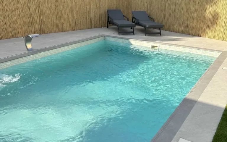 Tiled villa swimming pool with sun loungers in Dubai