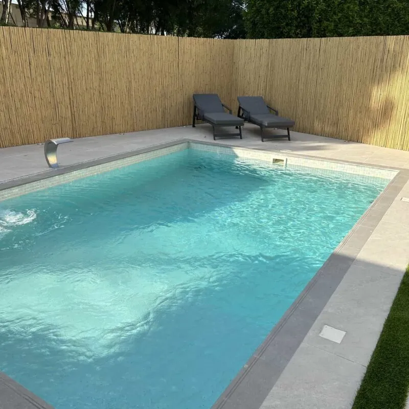 Swimming Pool Maintenance in Dubai 1 Swimming pool maintenance in Dubai: a clean villa pool with sun loungers