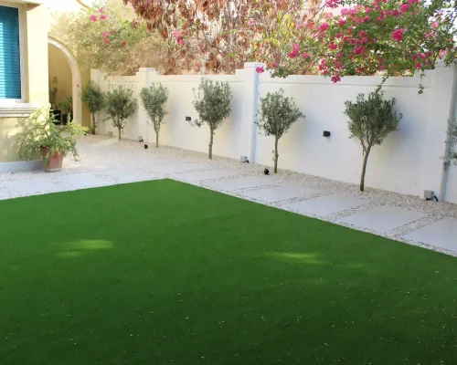 Clean artificial grass lawn in a Dubai villa garden with neat edges
