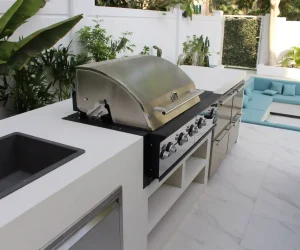 Custom built-in outdoor kitchen BBQ station with modern composite countertops for a Dubai villa patio.